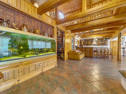 a large room with a fish tank and a bar at Holiday Home Borówna-1 by Interhome in Lipnica Górna