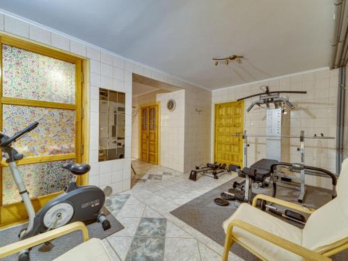 a fitness room with a gym with a treadmill and a exercise bike at Holiday Home Borówna-1 by Interhome in Lipnica Górna