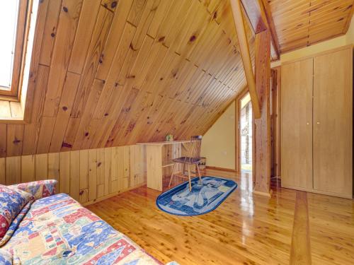 a living room with a couch and a wooden ceiling at Holiday Home Borówna-1 by Interhome in Lipnica Górna