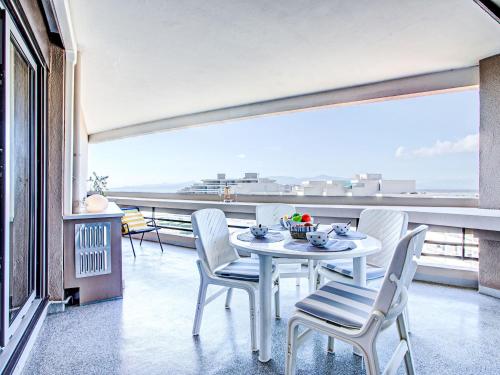 une table blanche et des chaises sur un balcon avec vue dans l'établissement Apartment Les Terrasses du Levant-24 by Interhome, à Canet