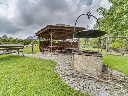a gazebo with a picnic table in a park at Holiday Home Borówna-1 by Interhome in Lipnica Górna