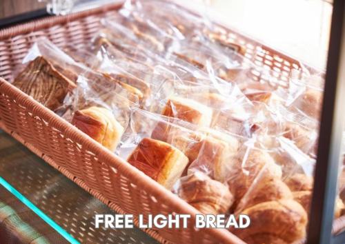 a basket full of bread in plastic bags at Hotel Pasela Living in Tokyo