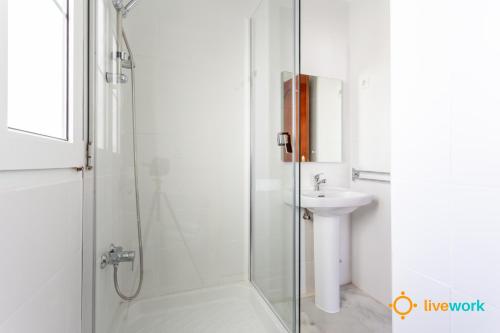 a bathroom with a shower and a sink at Torre Argantonio by LiveWork in Cádiz
