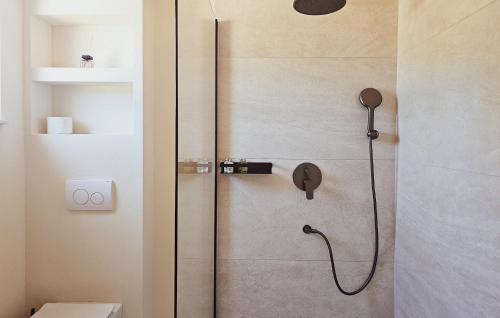 a shower in a bathroom with a glass door at 3 Bedroom Gorgeous Home In Zman in Žman