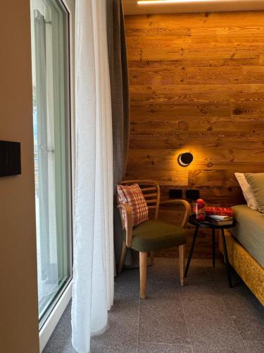 a room with a couch and a chair and a window at Lisa Da Pent in Canazei