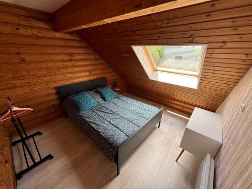 an overhead view of a bedroom in a log cabin at Le Chalet aux Trésors ! in Notre-Dame-dʼAllençon