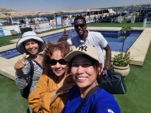three people posing for a picture at a tennis match at Five Star Nile Cruise from Aswan to Luxor in Aswan