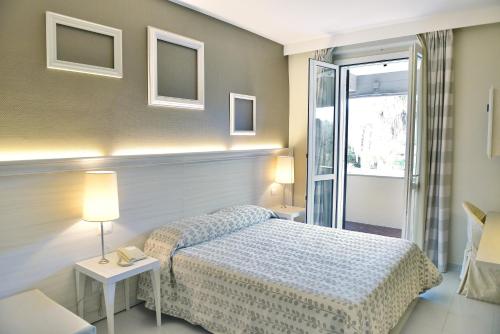 a hotel room with a bed and a window at Hotel Degli Ulivi in Ferrandina