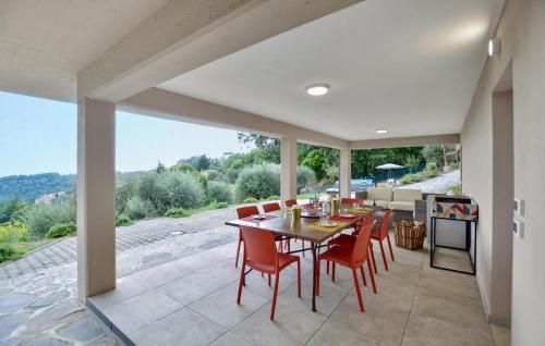a dining room with a table and red chairs at Splendida Casa In Corsanico in Massarosa