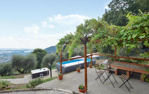 a patio with a pool and a table and chairs at Splendida Casa In Corsanico in Massarosa
