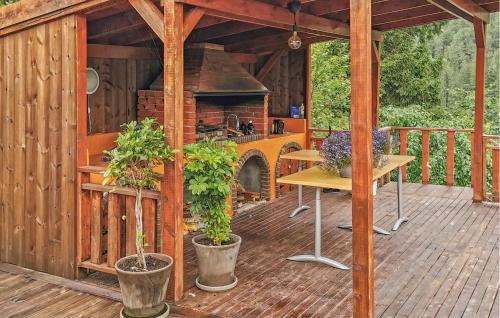 a wooden deck with an outdoor kitchen in a house at Gorgeous Home In Førde in Førde