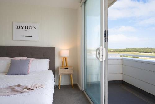 a bedroom with a bed and a sliding glass door at Schnapper Lane in Warrnambool