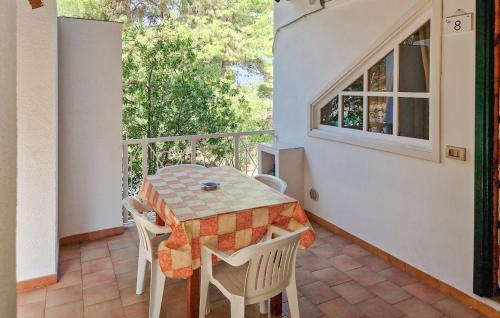 a porch with a table and chairs on a balcony at Gorgeous Home In Vieste in Vieste