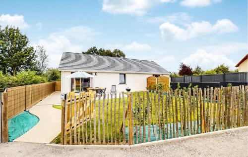 a fence in front of a house with a pool at Stunning Home In Angerville L'orcher in Angerville-lʼOrcher