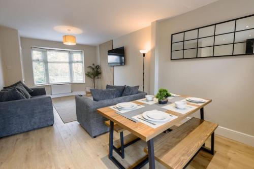 a living room with a table and a couch at 'Station House' Cosy Renovated Family-Friendly Home in Runcorn, Cheshire - Train Station Liverpool Chester Links, Brindley Theatre in Runcorn