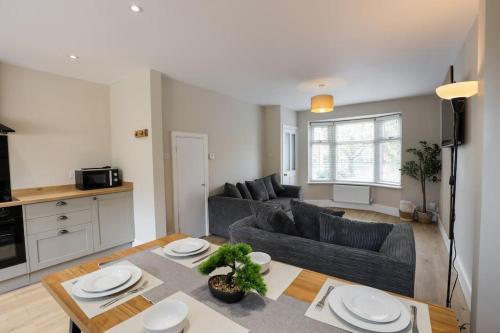 a living room with a couch and a table at 'Station House' Cosy Renovated Family-Friendly Home in Runcorn, Cheshire - Train Station Liverpool Chester Links, Brindley Theatre in Runcorn