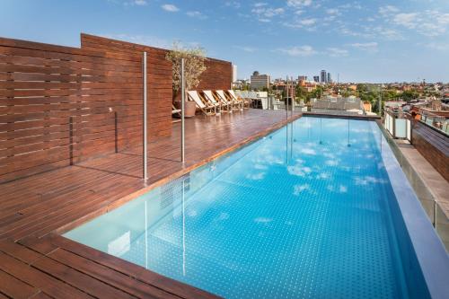 a swimming pool on the roof of a building at Melia Madrid Serrano in Madrid
