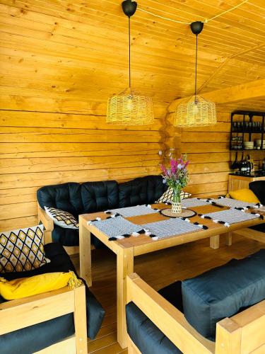 a wooden room with a table and a couch at FRIENDS HOUSE - Ізки 33 in Nizhniy Studenyy
