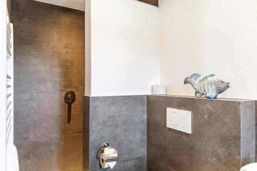 a bathroom with a fish statue on a counter at Berghoamat Nauders in Nauders