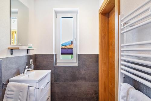 a bathroom with a sink and a window at Berghoamat Nauders in Nauders