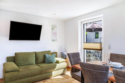 a living room with a couch and a table at Berghoamat Nauders in Nauders