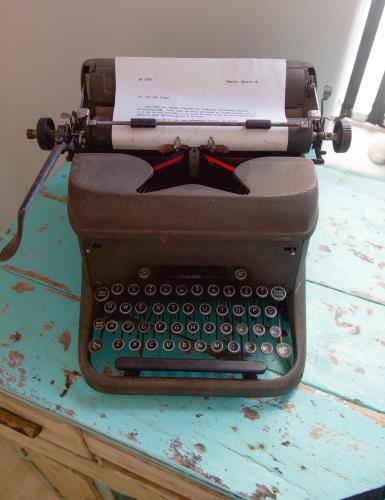 an old typewriter sitting on top of a table at LiveTulum in Tulum