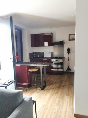 une cuisine et un salon avec une table et un canapé dans l'établissement La maison Kerserho, à Plouhinec