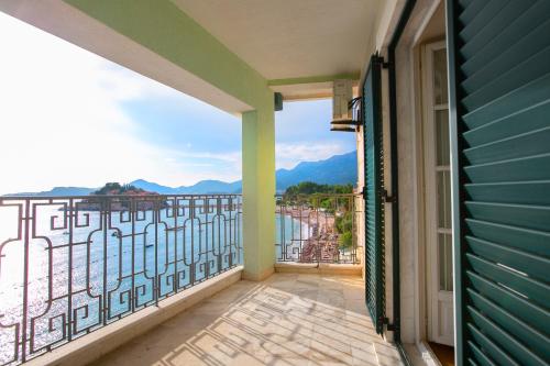 a balcony with a view of the water and mountains at Luxury Apartments Montesan in Sveti Stefan