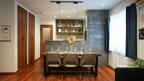 a dining room with a table and chairs at HOTELHOUSE Nekogoya Hachiken 八軒 in Ōdōri