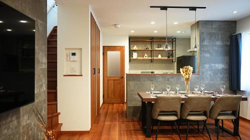 a dining room with a table and chairs at HOTELHOUSE Nekogoya Hachiken 八軒 in Ōdōri