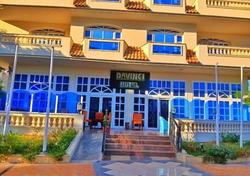 a hotel with blue windows and stairs in front of it at Davinci Beach Resort in Hurghada