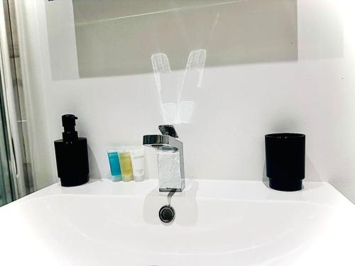 a white counter top with a blow dryer on it at Cozy Fully Equipped Loft Studio City Centre in Maidstone