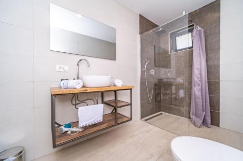 a bathroom with a sink and a shower at Villa Deavista by Villsy in Matulji