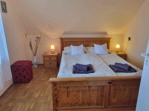 a bedroom with a large bed with two purple pillows at Apartment Balatonboglar 7 in Balatonboglár