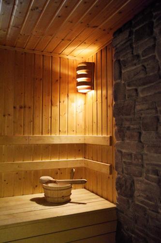 a wooden sauna with a light on the wall at Pokoje Gościnne u Wioli in Jurgów
