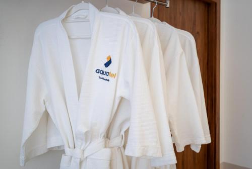 a group of white sweaters hanging on a rack at Aquatel Vung Tau in Vung Tau