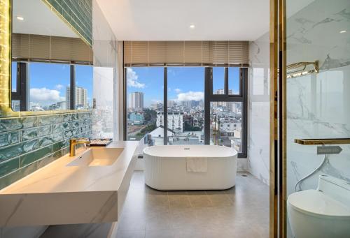 a bathroom with a tub and a view of the city at Aquatel Vung Tau in Vung Tau