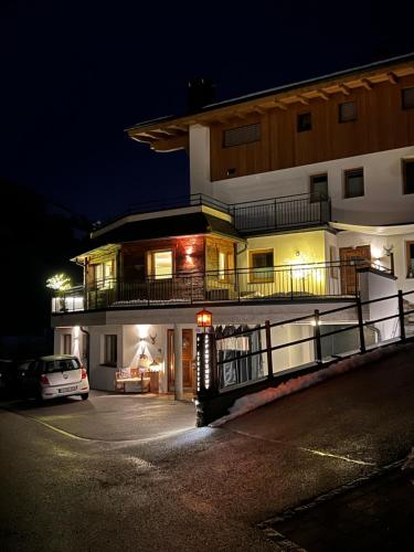 a building with a car parked in front of it at night at Tirol Chalet Brixen in Brixen im Thale