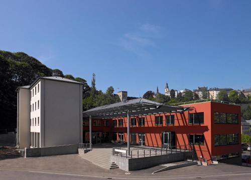 a building with a largeshed next to a building at Youth Hostel Luxembourg City in Luxembourg
