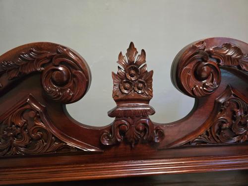 a close up of a wooden bed frame at Newly Renovated Historic 6-BR Manor plus 1-BR Apt, Where Timeless Elegance Meets Modern Luxury in Onancock