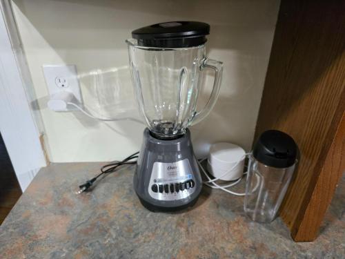 a blender sitting on top of a counter at Newly Renovated Historic 6-BR Manor plus 1-BR Apt, Where Timeless Elegance Meets Modern Luxury in Onancock