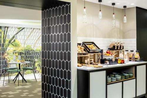 a bakery with a counter with food on it at Aparthotel Adagio Paris Centre Tour Eiffel in Paris