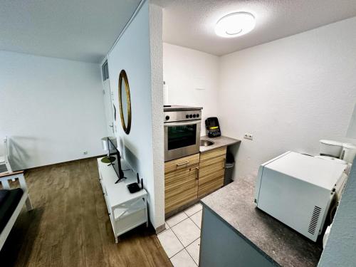 a small kitchen with a sink and a refrigerator at Moderne Ferienwohnung Nr 2 in Kleve - sehr zentral gelegen - in Kleve