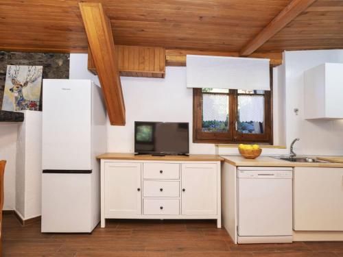 a kitchen with white appliances and wooden ceilings at Apartment Casita Alba by Interhome in Taull