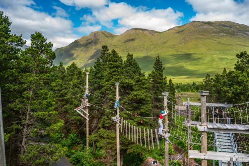 a group of people on a zip line in the mountains at Delphi Resort Hotel & Spa in Leenaun