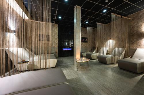 a salon with couches and chairs in a room at Santé SPA Hotel in Velingrad