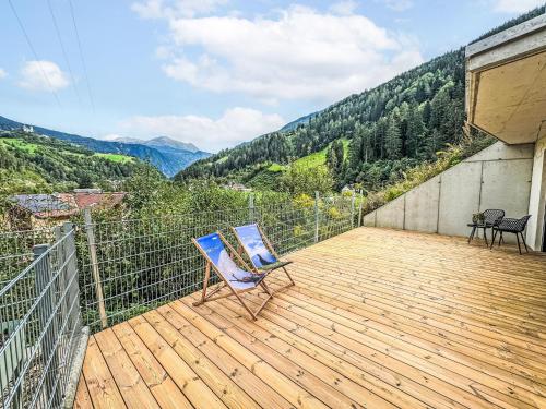 a chair sitting on a deck with a view at Apartment Urgen Living by Interhome in Fliess