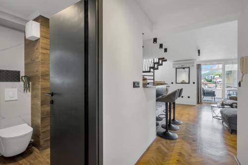 a living room with a toilet and a staircase in a house at Apartment Sanja Makarska Center in Makarska
