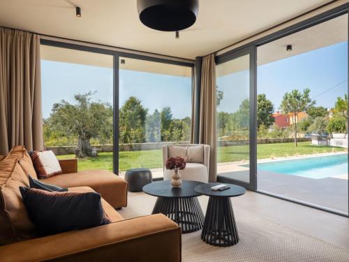 a living room with a view of a pool at Holiday Home Casa Tia 1 by Interhome in Nova Vas