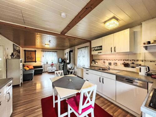 a kitchen with a table and chairs in a room at Holiday Home Ferienhaus Renata nahe Nürburgring by Interhome in Quiddelbach